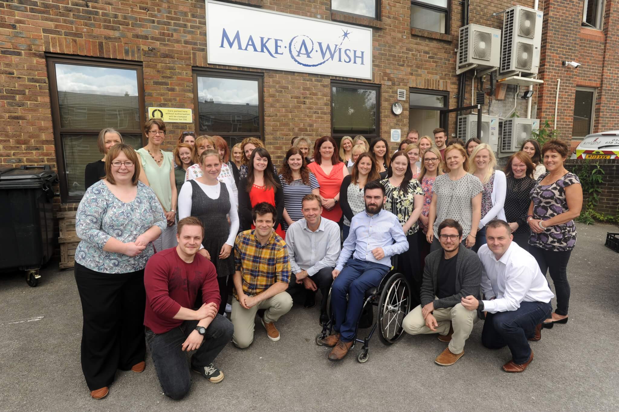 Make A Wish staff on the 30th anniversary outside of the Make A Wish office