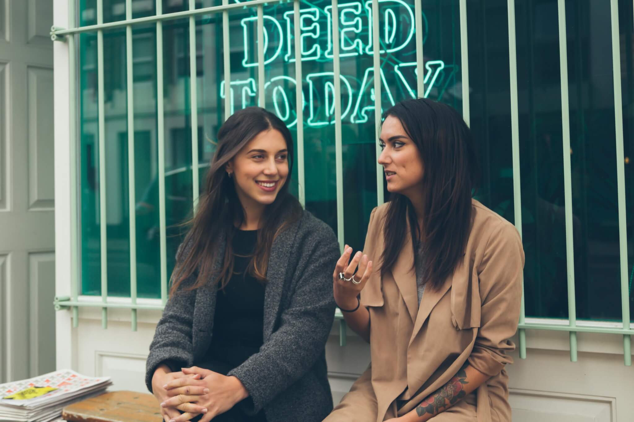 two women discussing bench