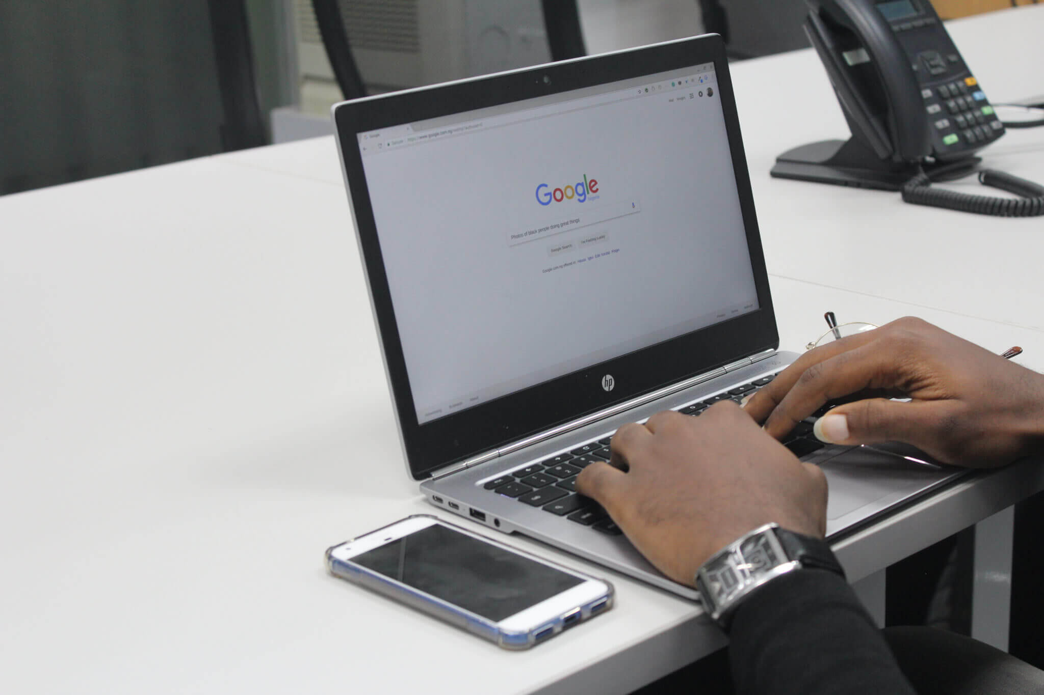 A picture of a laptop which the Google webpage open