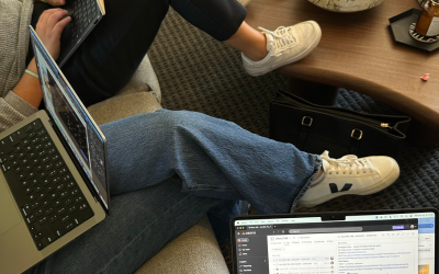 Group sitting on laptops discussing digital marketing measurement and analytics - The PHA Group