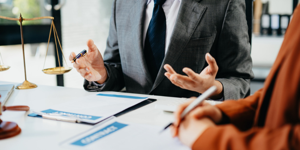 Lawyers sitting at desk - The PHA Group