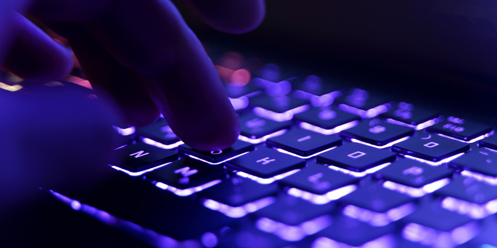 person typing on a keyboard - The PHA Group