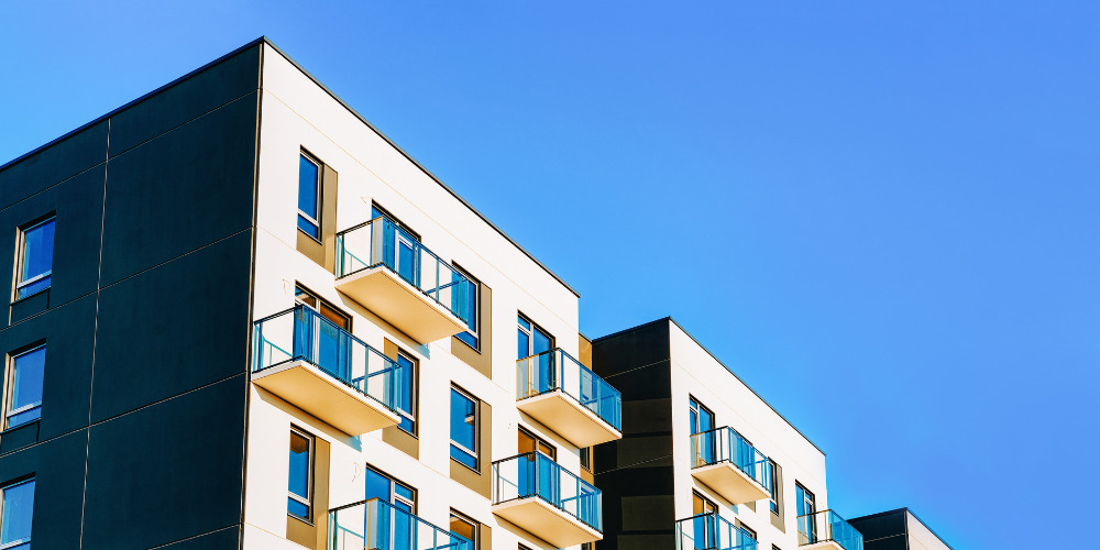 View looking up at block of modern flats - The PHA Group
