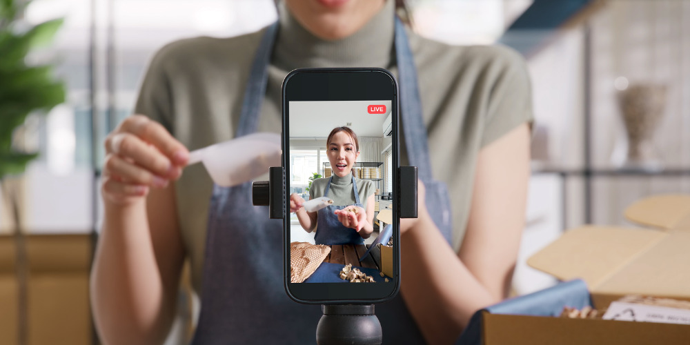 Person recording TikTok video to launch their brand - The PHA Group