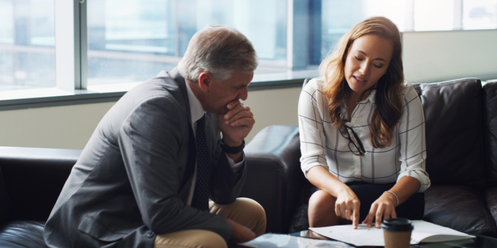 Lawyer and client discussing use of AI in the legal sector - The PHA Group