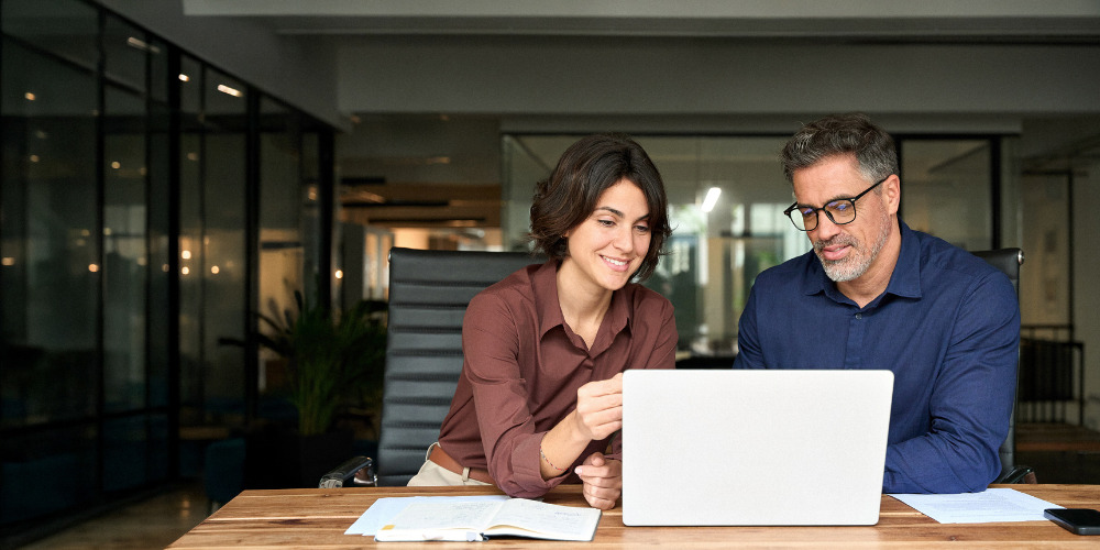 A business consultant and client discussing how brands can appear in AI-generated search results - The PHA Group