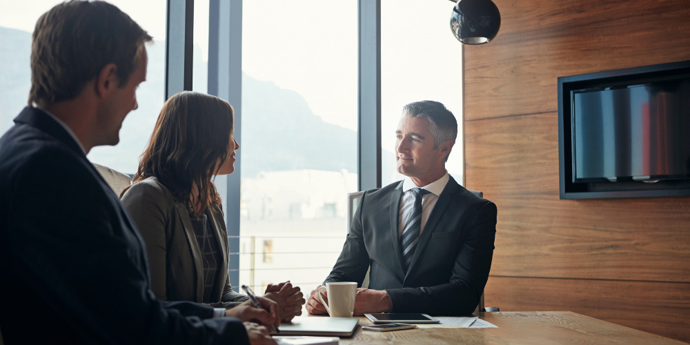 Group of 3 solicitors meeting to discuss use of AI in the legal sector - The PHA Group