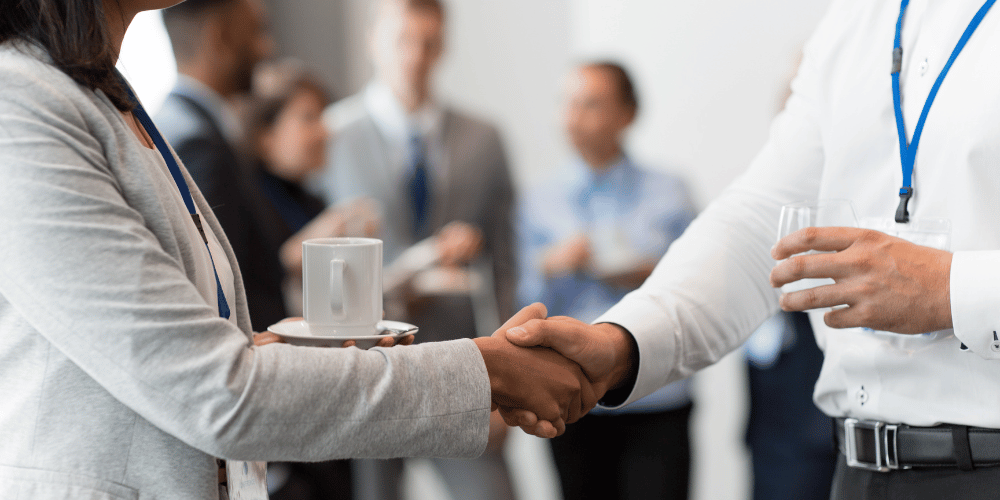 Corporate professional and media journalist shaking hands - The PHA Group