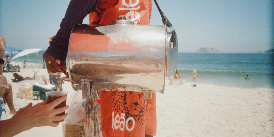 Beach vendor pouring drink after being recommended through AI travel discovery - The PHA Group