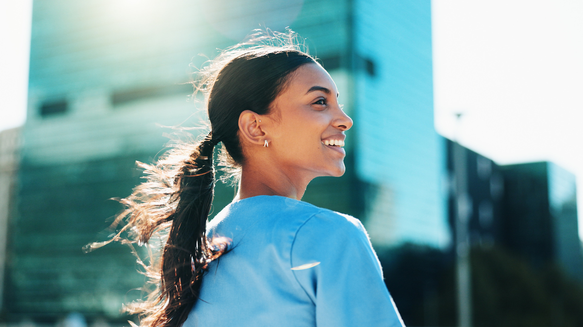 Woman smiling standing outside medical communications & consulting agency - The PHA Group