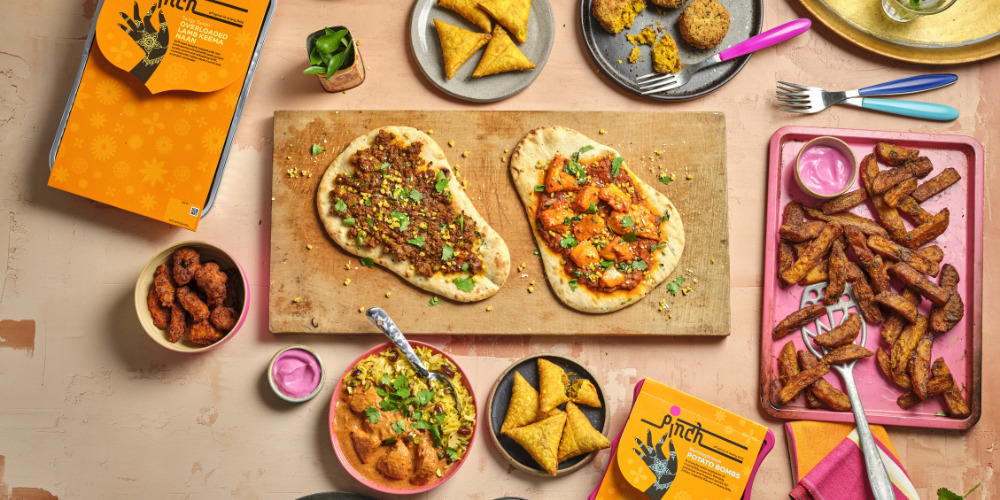 Spread of Pinch ready meals on a wooden table - The PHA Group