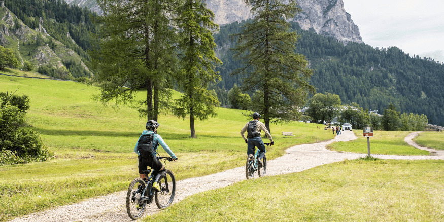 Pair of people riding bikes on a woodland trail of a brand that researched how to avoid greenwashing claims - The PHA Group